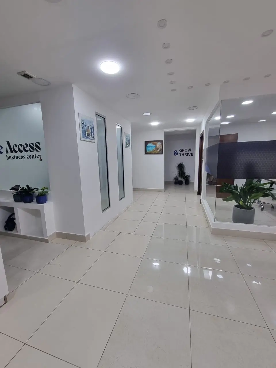 Photograph of The Access building entrance with glass walls and plants